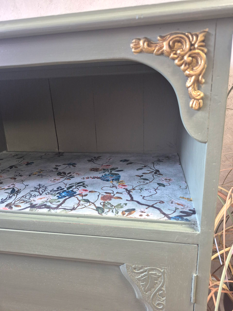 Vintage Cupboard
This cupboard is perfect for those who appreciate the beauty of imperfection and the charm of a well-loved piece. Whether used for storage or as a decorative accent, it brings warmth and authenticity to any home.

It has been painted with Fusion Alchemy in Rosemary with &nbsp;Annie Sloan Chalk Paint Wax in Clear. The decorative carvings have been painted with Gild Super Gold Paint.&nbsp;

Dimensions

Depth 43cm

Width 67cm

Height 81cm

Please note ship