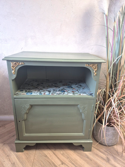 Vintage Cupboard
This cupboard is perfect for those who appreciate the beauty of imperfection and the charm of a well-loved piece. Whether used for storage or as a decorative accent, it brings warmth and authenticity to any home.

It has been painted with Fusion Alchemy in Rosemary with &nbsp;Annie Sloan Chalk Paint Wax in Clear. The decorative carvings have been painted with Gild Super Gold Paint.&nbsp;

Dimensions

Depth 43cm

Width 67cm

Height 81cm

Please note ship